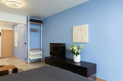 a bedroom with a bed and a blue wall at Cannes NEW Apartment, Palais Des Festivals, CROISETTE, Beaches in Cannes