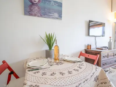 a dining room table with a table cloth on it at Apartment Le Trident by Interhome in Cannes