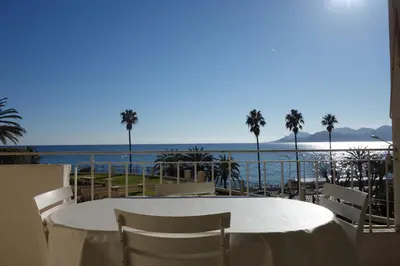 a table with chairs and a view of the ocean at Rocamare 2, by Welcome to Cannes in Cannes