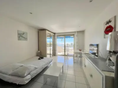 a bedroom with a bed and a counter with a window at Rocamare 2, by Welcome to Cannes in Cannes