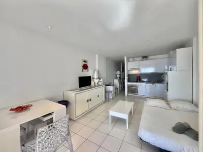 a white living room with a couch and a table at Rocamare 2, by Welcome to Cannes in Cannes