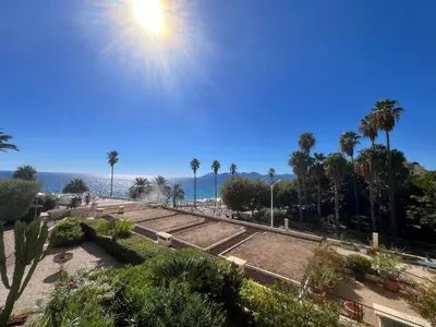 a view of a park with palm trees and the ocean at Rocamare 2, by Welcome to Cannes in Cannes