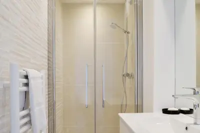 a shower with a glass door in a bathroom at IMMOGROOM - SEA VIEW - 2 min from beach - CONGRESSBEACHES in Cannes