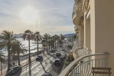 a balcony with a view of a street and palm trees at IMMOGROOM - SEA VIEW - 2 min from beach - CONGRESSBEACHES in Cannes