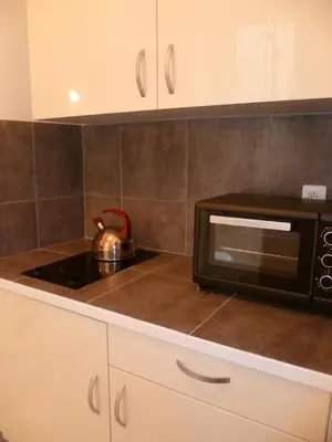 a kitchen with a sink and a washing machine at Karolina Properties - Misericorde Appartements in Cannes