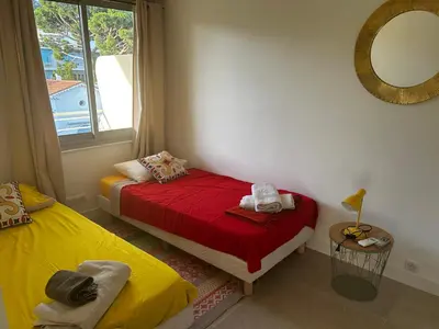 a bedroom with two beds and a mirror at Modern cosy two bedrooms in Cannes , large terrace, 5 minutes from Croisette in Cannes