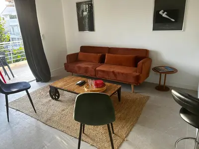 a living room with a couch and a coffee table at Modern cosy two bedrooms in Cannes , large terrace, 5 minutes from Croisette in Cannes
