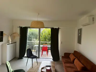a living room with a couch and a table at Modern cosy two bedrooms in Cannes , large terrace, 5 minutes from Croisette in Cannes