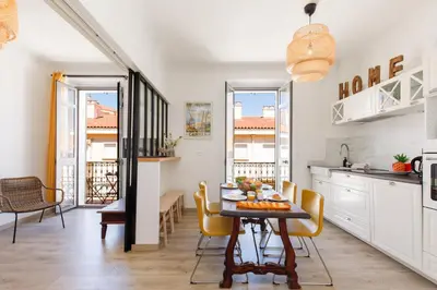 a kitchen and dining room with a table and chairs at La Colline YourHostHelper in Cannes