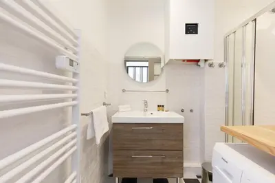 a bathroom with a sink and a mirror at La Colline YourHostHelper in Cannes