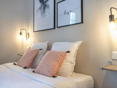 a bedroom with a bed with two pillows on it at Agences des Résidences - Rue Commandant André in Cannes