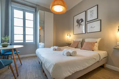 a bedroom with a large bed with towels on it at Agences des Résidences - Rue Commandant André in Cannes