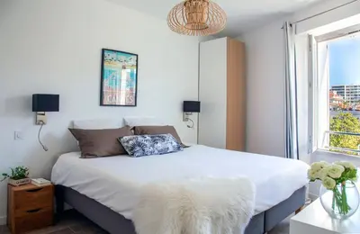 a bedroom with a white bed and a window at Prime Location Hyper Center Ideal for Couples & Families - Walk Everywhere - SMART by Totolulucannes in Cannes