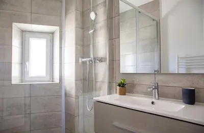 a bathroom with a shower and a sink and a mirror at Prime Location Hyper Center Ideal for Couples & Families - Walk Everywhere - SMART by Totolulucannes in Cannes