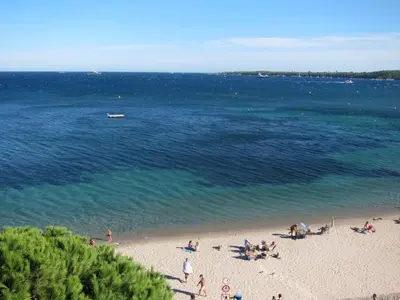 a group of people on a beach near the water at Fettolina Palm Beach, Location Cannes front de mer et plage in Cannes