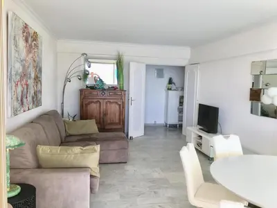 a living room with a couch and a table at Fettolina Palm Beach, Location Cannes front de mer et plage in Cannes
