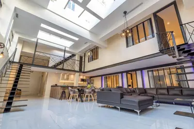 a living room with a couch and a table at Résidence Montaigne - Luxurious - 350m Palais - LRA Cannes in Cannes