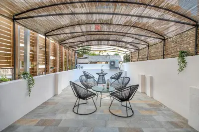 a room with chairs and a table on a patio at Résidence Montaigne - Luxurious - 350m Palais - LRA Cannes in Cannes