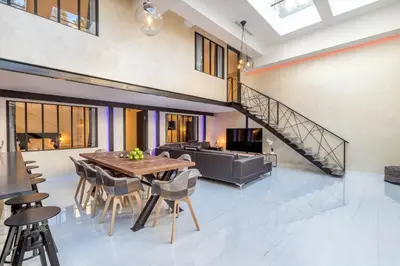 a dining room with a table and chairs at Résidence Montaigne - Luxurious - 350m Palais - LRA Cannes in Cannes