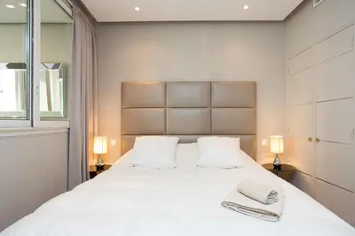 a bedroom with a large white bed with two towels on it at 24 Août Sucquet in Cannes