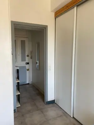 an empty hallway with an open door to a kitchen at Appartement PALOMA Proche Cannes in Le Cannet