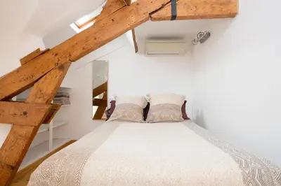 a bedroom with a bed in a attic at LB Vacation Rentals I Big Loft 107m2, 10min Walk to Palais des Festivals in Cannes