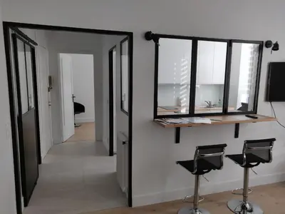 a hallway with a mirror and two stools at Cosy apartment in Cannes