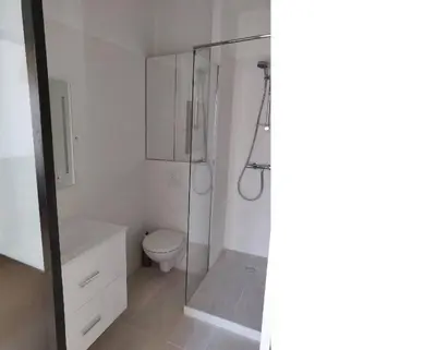 a bathroom with a toilet and a glass shower at Cosy apartment in Cannes