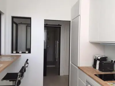 a kitchen with white walls and a counter top at Cosy apartment in Cannes
