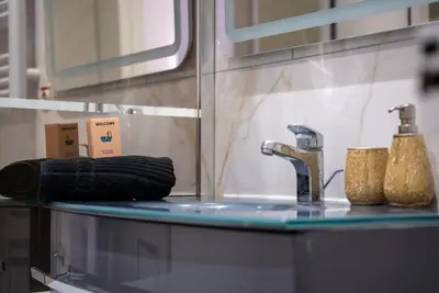a bathroom counter with a sink and a faucet at Central Cannes, 200m to Palais, walk everywhere in Cannes