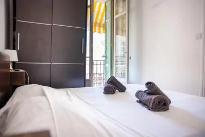 a bed with two towels sitting on top of it at Central Cannes, 200m to Palais, walk everywhere in Cannes