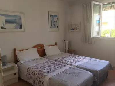 a bedroom with two beds and a window at Lisa V apart in Cannes