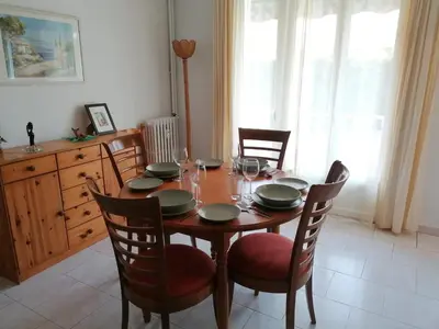 a dining room table with chairs and a table with glasses at Lisa V apart in Cannes