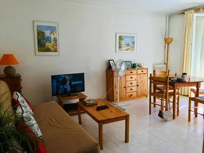 a living room with a couch and a table at Lisa V apart in Cannes