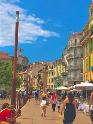 a group of people walking down a city street at Lisa V apart in Cannes