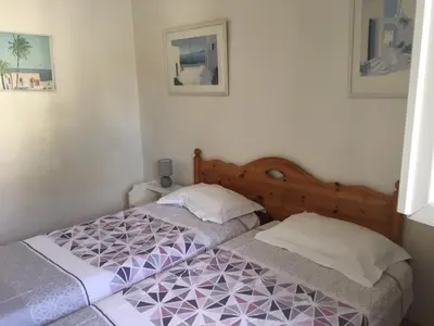 a bedroom with two beds with purple and white at Lisa V apart in Cannes