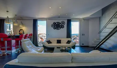 a living room with a white couch and chairs at RG Duplex - Sea View - Palais & Croisette - Luxury Stay by LRA Cannes in Cannes