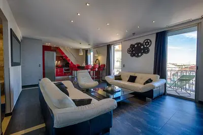 a living room with two couches and a table at RG Duplex - Sea View - Palais & Croisette - Luxury Stay by LRA Cannes in Cannes