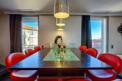 a dining room with a table and red chairs at RG Duplex - Sea View - Palais & Croisette - Luxury Stay by LRA Cannes in Cannes