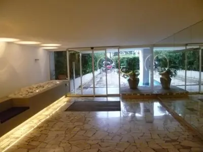 a lobby with glass doors and vases on the floor at Karolina Properties - Appartement Commodore Croisette in Cannes
