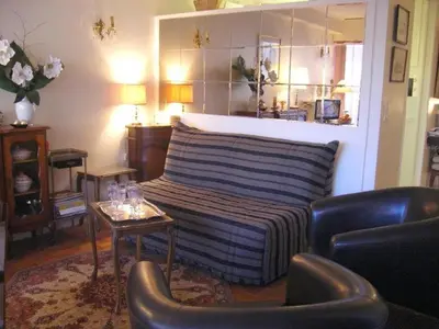 a living room with a couch and a table and chairs at Karolina Properties - Appartement Commodore Croisette in Cannes