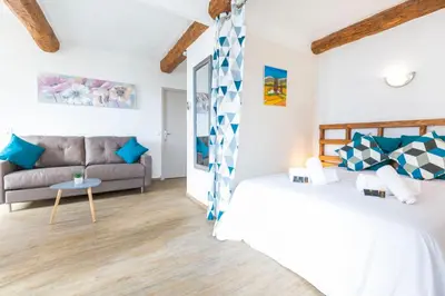a living room with two beds and a couch at Résidence Le Suquet in Cannes