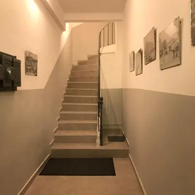a staircase in a building with pictures on the wall at Résidence Le Suquet in Cannes