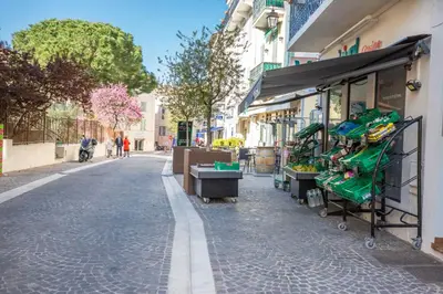 a street with a fruit stand on the side of a building at Résidence Le Suquet in Cannes