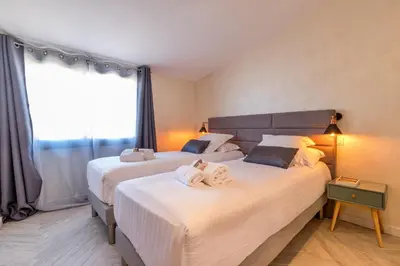 a bedroom with two beds with towels on them at Residence Provencal - Luxurious - 300m Palais - LRA CANNES in Cannes