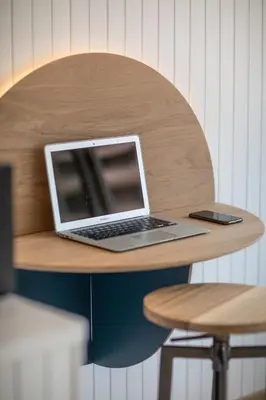 a laptop computer sitting on top of a wooden table at Belle surprise cœur de ville, cosy avec terrasse in Cannes