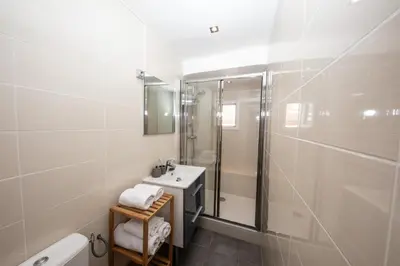 a white bathroom with a sink and a shower at Belle surprise cœur de ville, cosy avec terrasse in Cannes