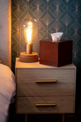 a nightstand with a lamp and a box on it at Belle surprise cœur de ville, cosy avec terrasse in Cannes