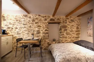 a bedroom with a bed and a table with chairs at Studio Suquet Saint Antoine in Cannes