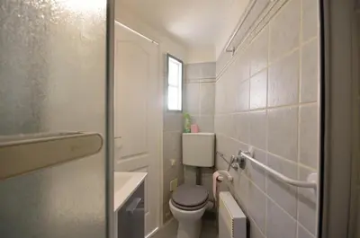 a small bathroom with a toilet and a sink at Studio Suquet Saint Antoine in Cannes